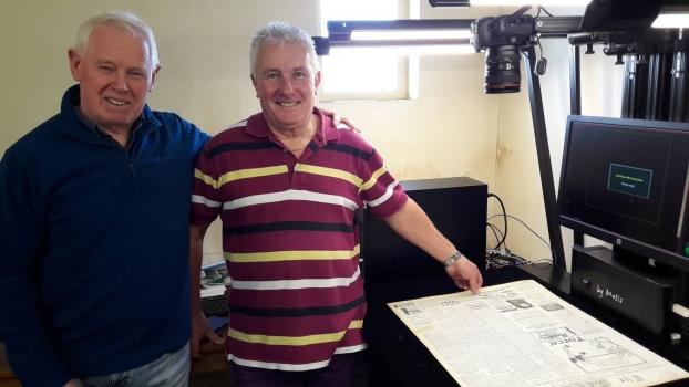 Volunteers Barry Gibson and Alan Solway using the large Metis scanner to digitise the newspaper collection