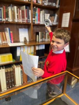 George Foote is looking for clues with his magnifying glass